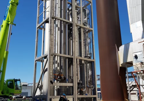 Large steel frames being lifted into place for a carbon capture facility